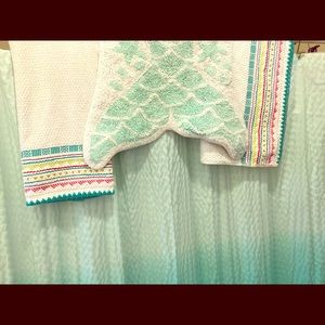 Shower curtain, tassels turquoise, towels rug.